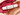 A white Beauty Baton makeup stick with gold and black stripes and a pink cap, resting diagonally over textured metallic pink and copper cream swatches on a light beige surface.